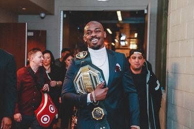 Jon Jones IG Post - New belt. New suit. Same smile #blessed #andsti...